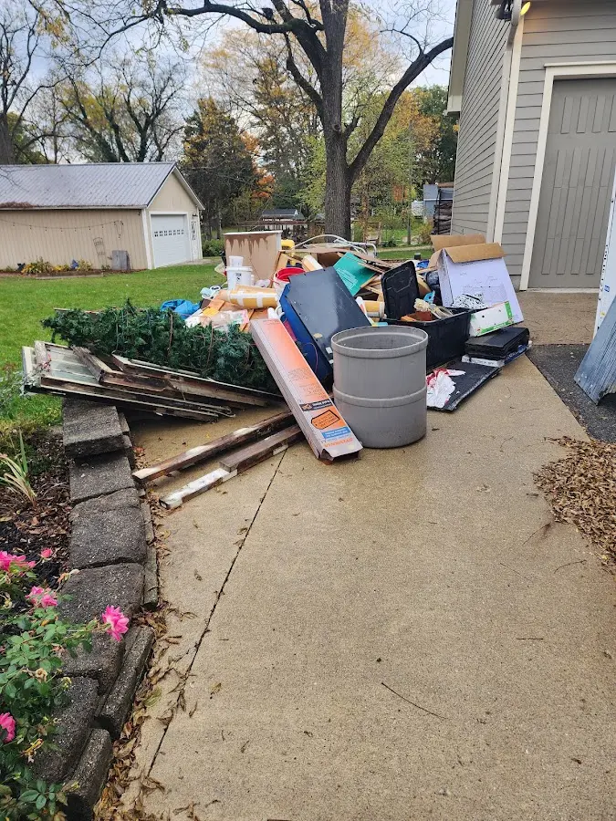 Dumpster being loaded with debris for 30 Yard Dumpster Rental in Myrtle Grove